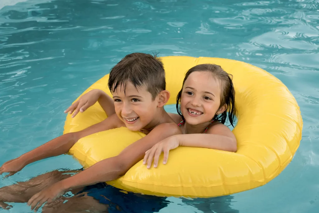 children playing on a float in the pool.